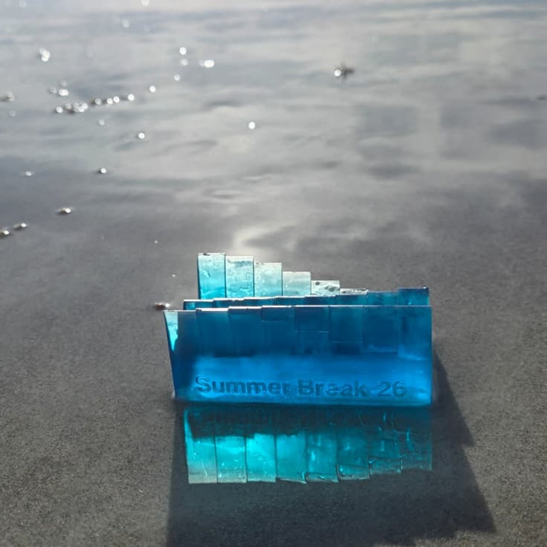 Blue tide keepsake reflected on the wet beach